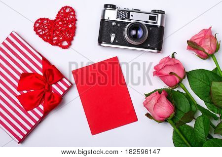 Romantic Concept On White Background: Roses, Gift And Old Camera.