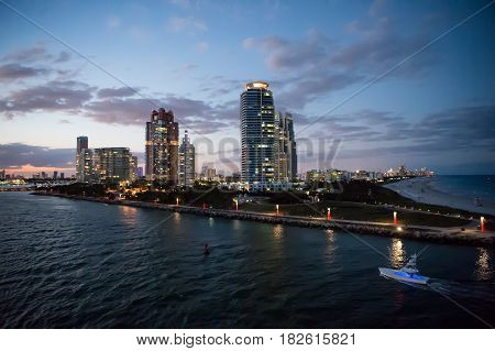 Miami skyscrapers with blue cloudy skywhite boat next to Miami downtown Aerial view