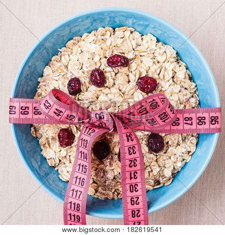Oatmeal In Blue Bowl With Measuring Tape Around