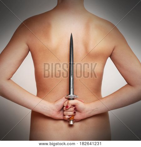 Woman with hidden dagger. Symbol for insidious behavior. Crime and home violence theme.