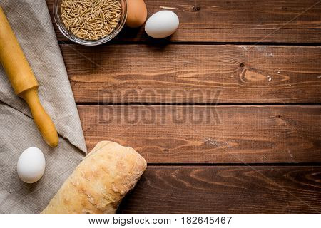 bakery concept with homemade fresh wheat bread on rustic kitchen table background top view moke-up