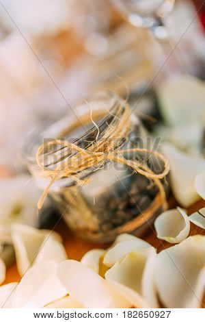 Healthy blueberry and raspberry parfait in a mason jar on a rustic white wood background