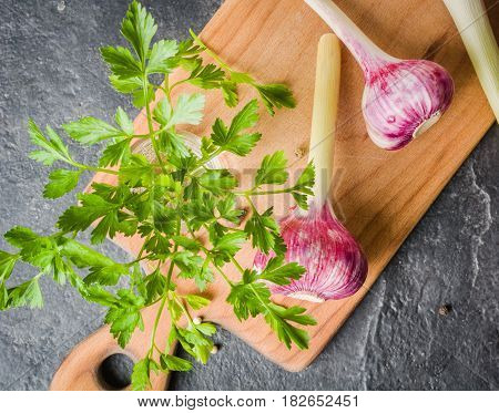 Fresh Parsley And Garlic On Cutting Board