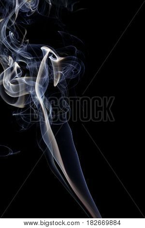 Abstract art. Color white blue smoke from the aromatic sticks on a black background. Background for Halloween. Texture fog. Design element. The concept of aromatherapy.
