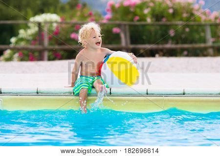 Child In Swimming Pool On Summer Vacation
