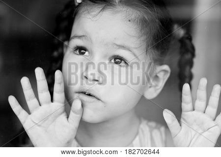 Portrat of sad mix asian girl by the window