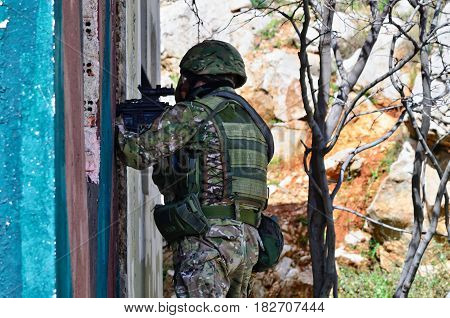 Special forces soldier aim target with sub machine gun