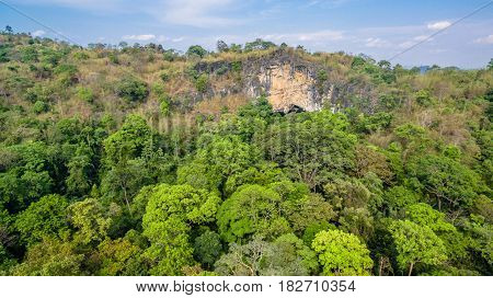 aerial photography above amazing cave. Tham Than Lod Yai is the big cave and have one hole on the top of the cave. it is a short cave there have waterfall pass inside through to another cave