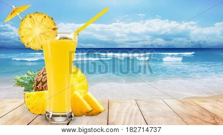 pineapple juice glass pineapple and slices on wooden beach table in sea shore
