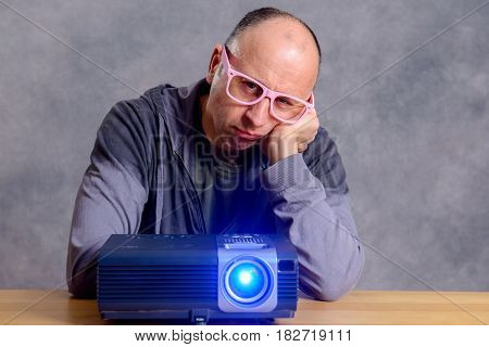 Young Man With Projektor Watch Boring Film