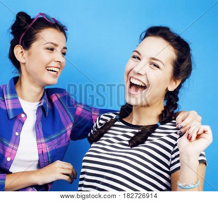 best friends teenage school girls together having fun, posing emotional on blue background, besties happy smiling, lifestyle people concept close up