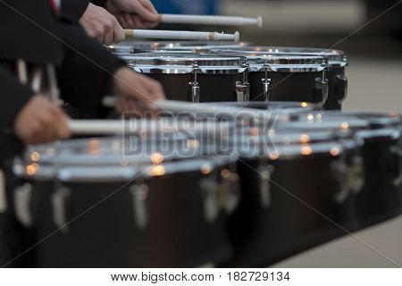 two snare drummers warming up before the bands performance at a football game