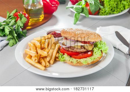 Tasty Burger Set - Meat Burger, French Fries And Sause On The White Round Plate On The Served Table