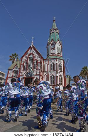 ARICA, CHILE - FEBRUARY 11, 2017: Caporales dancers in ornate costumes performing at the annual Carnaval Andino con la Fuerza del Sol in Arica, Chile.
