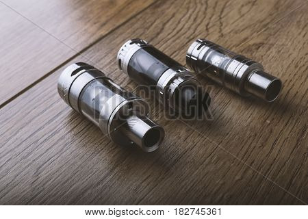 Vape Pen And Vaping Devices, Mods, Atomizers, E Cig, E Cigarette On A Wooden Background.