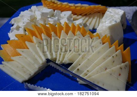 slices of assorted cheese
Different kinds of cheese sliced and arranged on a platter
