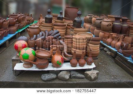 Handmade clay pots jars drinking horn. Ceramic ware with jugs plates and cups
