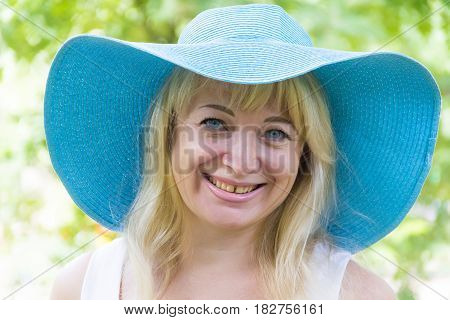 Photo of European blond woman in blue hat