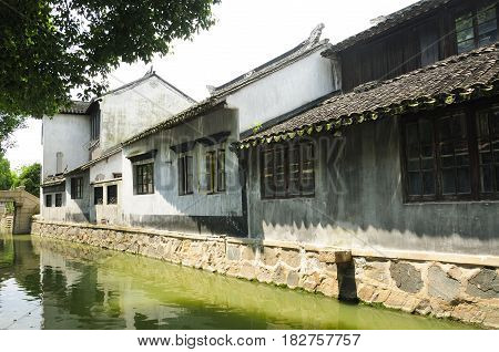 Chinese style buildings lining the water canals inside of Luzhi water town in Jiangsu province near Suzhou China.