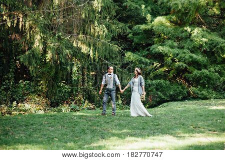 Happy Couple Walking In Summer Park