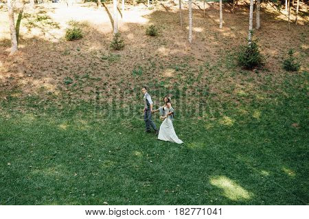 Happy Couple Walking In Summer Park