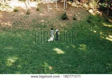 Happy Couple Walking In Summer Park