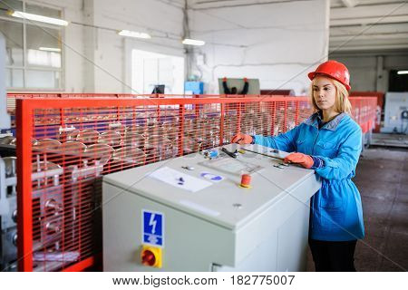Woman In Red Safety Helmet Work As Industrial Worker