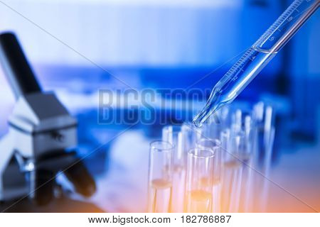 Lab experiment. Laboratory concept background.
Tubes during experiment in laboratory. Colorful bokeh.