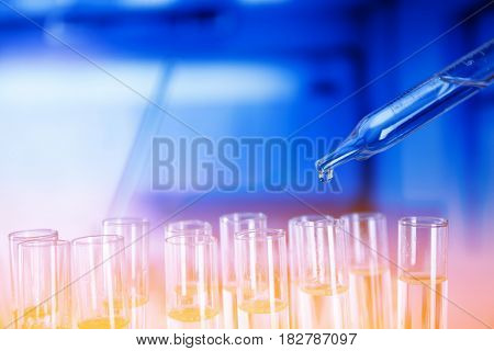 Lab experiment. Laboratory concept background.
Tubes during experiment in laboratory. Colorful bokeh.