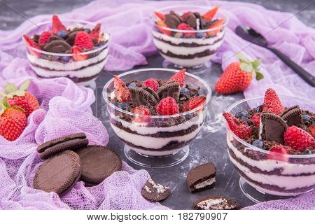 A berry dessert on a basis cream cheese with mascarpone, with cookies and fresh berries