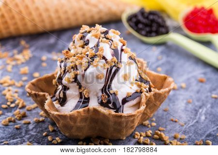 Ice cream with chocolate jam, is served with shredded nut
