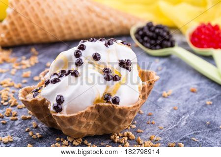 Lemon ice cream with a basket with chocolate balls and lemon jam