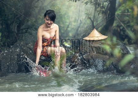 Asian sexy woman bathing in creek Thailand