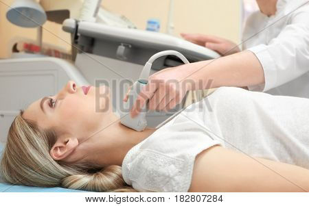 Young woman undergoing ultrasound scan in modern clinic