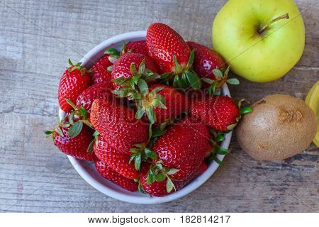 Top view of red strawberry green apple and kiwi fruit as ripe and fresh sweet concept.