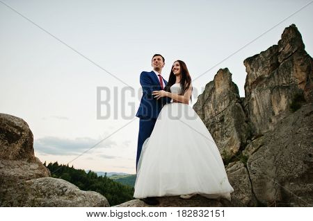 Lovely Wedding Couple Against Rocks Of Fortess Tustan At Carpathian Mountains.