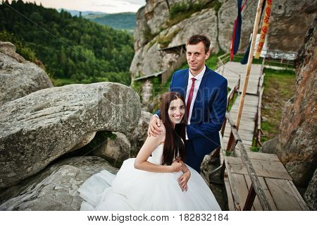 Lovely Wedding Couple Against Rocks Of Fortess Tustan At Carpathian Mountains.