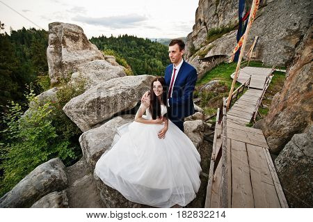 Lovely Wedding Couple Against Rocks Of Fortess Tustan At Carpathian Mountains.