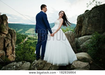 Lovely Wedding Couple Against Rocks Of Fortess Tustan At Carpathian Mountains.