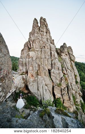 Lovely Wedding Couple Against Rocks Of Fortess Tustan At Carpathian Mountains.