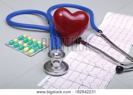 RX prescription, Red heart, asorted pils and a stethoscope on white background.