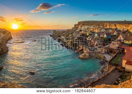 il-Mellieha Malta - Panoramic view of the famous Popeye Village at Anchor Bay at sunset