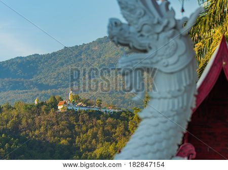Old temple and holy Buddha statue on mountain at Wat Phra That Doi Kham temple Chiang Mai Thailand