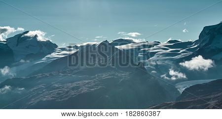 Snow capped mountains. Summits of the mountains. View of the Alpine mountains at the sunrise. Trek near Matterhorn mount.