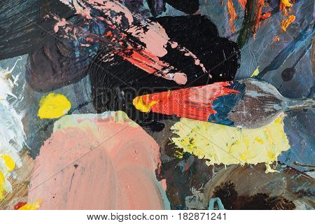Palette knife with oil painting colors on pallette background