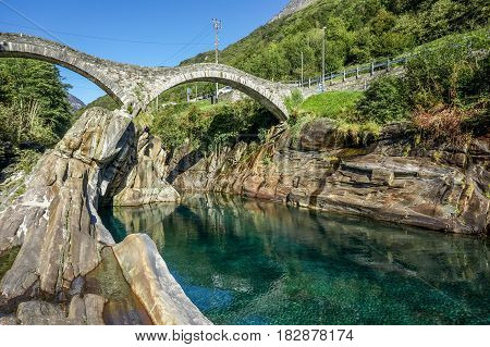 Stone bridge with clear clean green water river ready to swim in summer