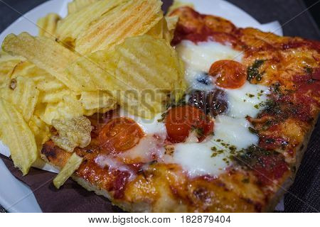 Closed up of italian traditional tomato pizza with fried chips