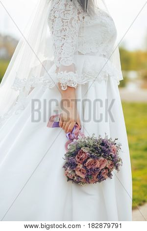 wedding bouquet in his hand of the bride