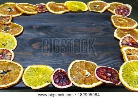 Fruits Of Dried Orange And Lemon On A Wooden Background.