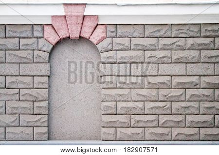 Wall of large stones. In the wall an imitation of the arch with a keystone. There is a free place for text.